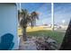 Small patio with teal chair and palm tree, ocean view at 2850 Ocean Shore Blvd # 8, Ormond Beach, FL 32176