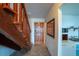 Indoor photo of wooden staircase, tiled floor, and partial kitchen view at 2850 Ocean Shore Blvd # 8, Ormond Beach, FL 32176