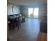 Living and dining area with coastal decor and beach access through sliding glass doors at 2850 Ocean Shore Blvd # 8, Ormond Beach, FL 32176