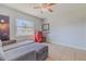 Bedroom with gray couch and ceiling fan at 328 Dubs Dr, Holly Hill, FL 32117