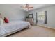 Spacious bedroom with ceiling fan and large window at 328 Dubs Dr, Holly Hill, FL 32117