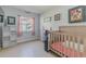 Charming bedroom with crib and built-in shelving at 328 Dubs Dr, Holly Hill, FL 32117