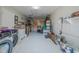 Garage with workshop area and storage shelving at 328 Dubs Dr, Holly Hill, FL 32117