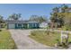 Quaint teal house with circular driveway at 328 Dubs Dr, Holly Hill, FL 32117