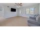 Living room with tile flooring, gray couch, and a large TV at 328 Dubs Dr, Holly Hill, FL 32117