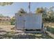 Grey storage shed with small garden at 328 Dubs Dr, Holly Hill, FL 32117