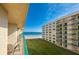 Balcony view of ocean, beach, and neighboring building at 4565 S Atlantic Ave # 5411, Ponce Inlet, FL 32127