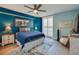 Spacious bedroom with blue color scheme, ceiling fan, and hardwood floors at 4565 S Atlantic Ave # 5411, Ponce Inlet, FL 32127