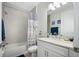 Clean bathroom with shower/tub combo, white vanity, and nautical-themed decor at 508 High Tide Ln, Daytona Beach, FL 32124