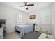 Bedroom with blue and white bedding and ceiling fan at 508 High Tide Ln, Daytona Beach, FL 32124