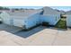 Rear view of the property showcasing two-car garage and parking at 508 High Tide Ln, Daytona Beach, FL 32124