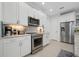 Modern kitchen featuring stainless steel appliances and white cabinetry at 508 High Tide Ln, Daytona Beach, FL 32124