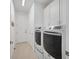 Bright laundry room with washer, dryer, and ample storage at 508 High Tide Ln, Daytona Beach, FL 32124