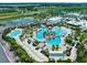 Aerial view of resort-style pool with multiple pools, palm trees, and lounge chairs at 508 High Tide Ln, Daytona Beach, FL 32124