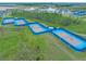 Community tennis courts with blue fencing and lighting at 508 High Tide Ln, Daytona Beach, FL 32124