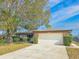 Brick home with attached garage and neatly landscaped yard at 840 Chickadee Dr, Port Orange, FL 32127