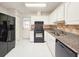 Kitchen with granite countertops and white cabinets at 840 Chickadee Dr, Port Orange, FL 32127