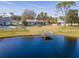 Lake view of house from backyard with dock at 840 Chickadee Dr, Port Orange, FL 32127