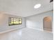 Living room with tile floors and large window providing natural light at 840 Chickadee Dr, Port Orange, FL 32127