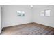 This bedroom features wood-look flooring, white walls, and dual windows for natural light at 1 Overbrook Ct, Ormond Beach, FL 32174