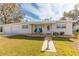 Cute ranch home with attached two-car garage and landscaped lawn at 105 Park Cir, Daytona Beach, FL 32117