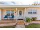 Inviting front porch with seating and decorative bird bath at 105 Park Cir, Daytona Beach, FL 32117