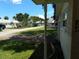 View of the home's front yard, driveway, and a tree-lined street leading to a waterfront at 105 Park Cir, Daytona Beach, FL 32117