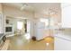 Galley style kitchen with white cabinets and view of dining area at 105 Park Cir, Daytona Beach, FL 32117