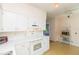 Bright kitchen with white cabinets, and view into the dining area at 105 Park Cir, Daytona Beach, FL 32117