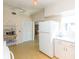 Bright kitchen features white appliances and a charming vintage-style baker's rack at 105 Park Cir, Daytona Beach, FL 32117