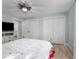 Bedroom with double doors, ceiling fan, and a large bed at 21 Tipperary Ln, Ormond Beach, FL 32176