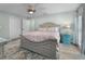 Bedroom with light walls, wooden bed frame, and ceiling fan at 21 Tipperary Ln, Ormond Beach, FL 32176