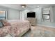 Main bedroom with a TV, dresser, and large bed at 21 Tipperary Ln, Ormond Beach, FL 32176