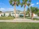 Single-story house with a light green exterior and palm trees at 21 Tipperary Ln, Ormond Beach, FL 32176