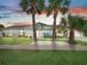 Charming single-story home with palm trees and landscaped lawn at 21 Tipperary Ln, Ormond Beach, FL 32176