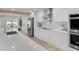 Modern kitchen with white cabinets, quartz countertops and stainless steel appliances at 21 Tipperary Ln, Ormond Beach, FL 32176