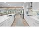 Open concept kitchen with white cabinets, island, and stainless steel appliances at 21 Tipperary Ln, Ormond Beach, FL 32176