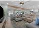 Spacious living room featuring light colored sofas and a large TV at 21 Tipperary Ln, Ormond Beach, FL 32176