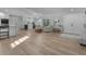 Open concept living and kitchen area with light wood floors at 21 Tipperary Ln, Ormond Beach, FL 32176