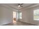 A bedroom featuring a ceiling fan and an ensuite bathroom, with light, neutral decor at 2869 Monaghan Dr, Ormond Beach, FL 32174