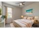 Stylishly staged bedroom with a plush bed, beach art, curtains and coordinating decor at 2869 Monaghan Dr, Ormond Beach, FL 32174