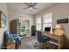 Bright home office featuring built-in bookshelf, light wood desk, and comfortable blue accent chair at 2869 Monaghan Dr, Ormond Beach, FL 32174