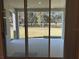 Covered back porch offers a serene view of the expansive lawn and surrounding greenery at 3142 Silvermines Ave, Ormond Beach, FL 32174