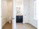 View of bathroom and toilet room with tile floors, granite countertop, dark wood cabinets at 3142 Silvermines Ave, Ormond Beach, FL 32174