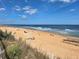 Expansive beach with sandy shoreline, clear blue skies, and gentle waves, perfect for relaxation and recreation at 3142 Silvermines Ave, Ormond Beach, FL 32174
