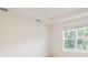 Bright bedroom features neutral walls, large window offering lush outdoor views, and tray ceiling at 3142 Silvermines Ave, Ormond Beach, FL 32174