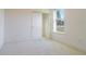 Bedroom features a window, neutral walls, plush carpet, and a sliding closet door at 3142 Silvermines Ave, Ormond Beach, FL 32174