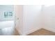 Hallway boasts wood-look tile flooring, neutral walls, and leads to a bright room with large window at 3142 Silvermines Ave, Ormond Beach, FL 32174