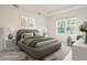 Bright main bedroom featuring a large window with a view of the outdoors and comfortable modern decor at 3142 Silvermines Ave, Ormond Beach, FL 32174