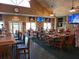 Lively restaurant with casual seating, multiple TVs, and flag decor for community enjoyment at 3142 Silvermines Ave, Ormond Beach, FL 32174